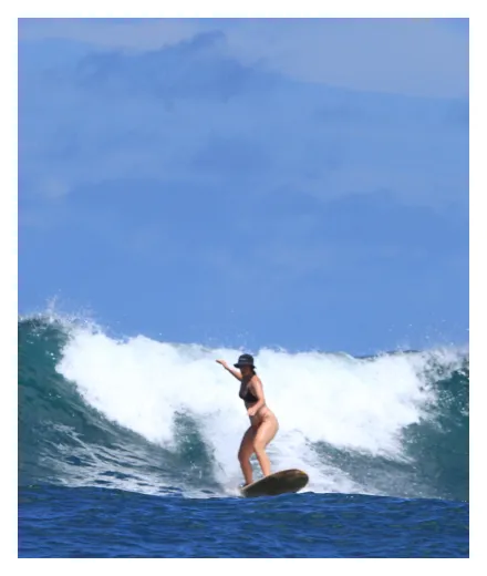 Sofia surfing a wave